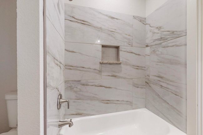 Bathroom featuring shower / bathing tub combination and toilet | Image 22