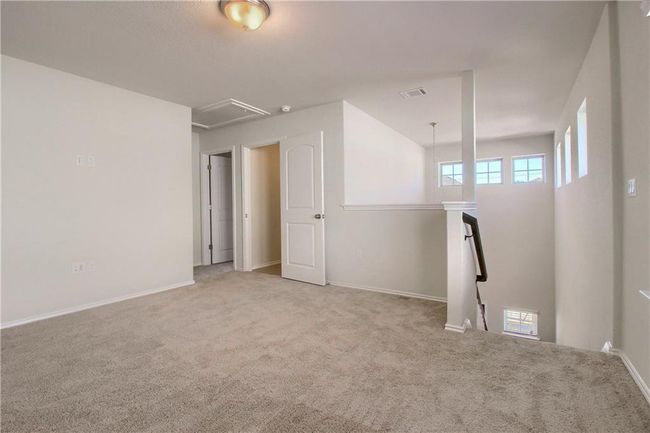 Unfurnished room with carpet flooring, attic access, and baseboards | Image 17
