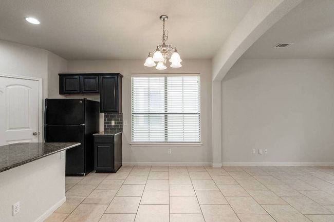 Another view of dining area and kitchen. | Image 15