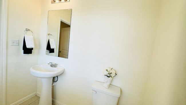 Half bathroom featuring toilet and baseboards | Image 9