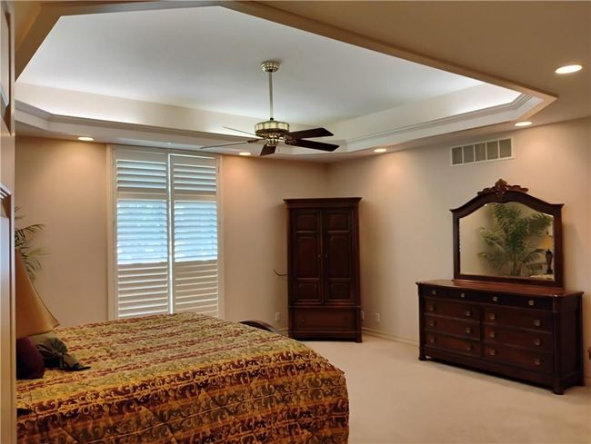 Carpeted bedroom with recessed lighting, a raised ceiling, and a ceiling fan | Image 44