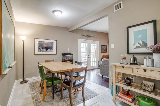 Dining area featuring french doors, light tile patterned floors, and beamed ceiling | Image 11