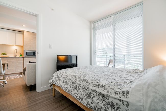 Bedroom featuring recessed lighting, baseboards, wood finished floors, and a sink | Image 23