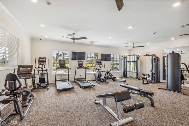 Workout area with ornamental molding, ceiling fan, and carpet floors | Image 11