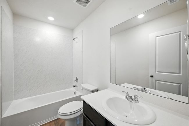 Bathroom featuring vanity, shower / washtub combination, wood finished floors, and recessed lighting | Image 18
