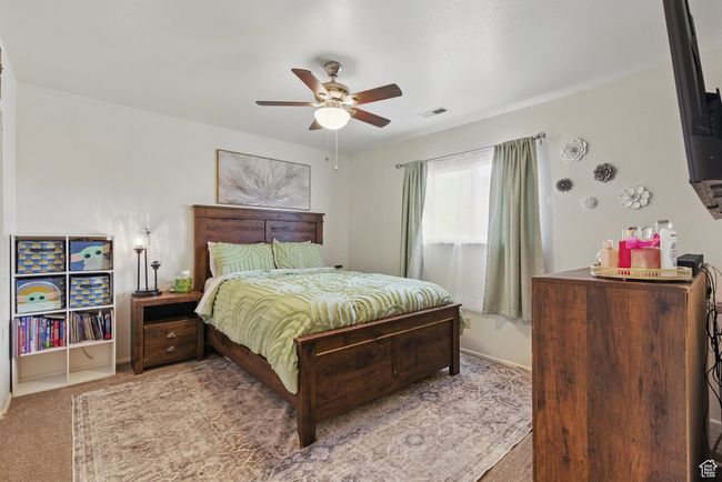 Carpeted bedroom with ceiling fan and visible vents | Image 30