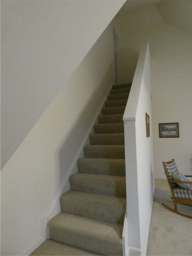 Tucked away in Bedroom 2 is a staircase to the huge storage attic above | Image 34