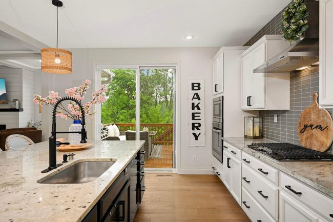 This inviting kitchen provides a walk-out to the deck, making this great for entertaining. | Image 19