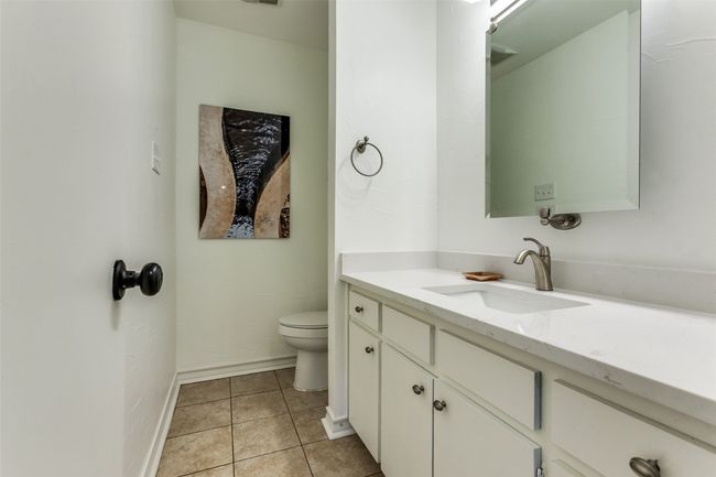 Powder room has new quartz on the vanity. | Image 13