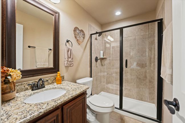 Full bathroom featuring vanity, a shower stall, and toilet | Image 34