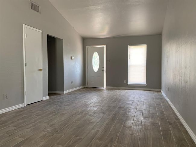 Foyer with dark wood-type flooring and lofted ceiling | Image 4