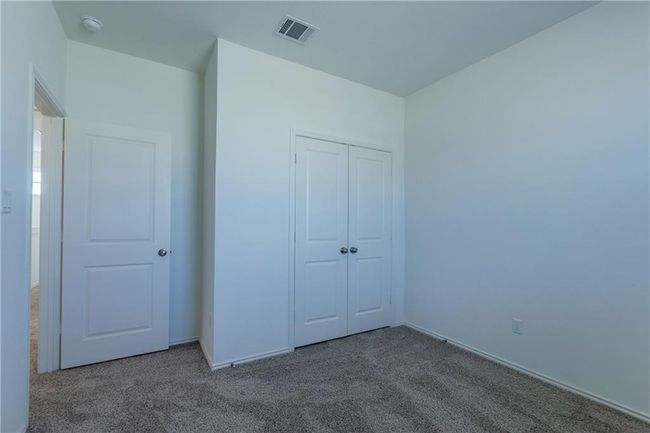 Unfurnished bedroom with carpet floors and a closet | Image 27