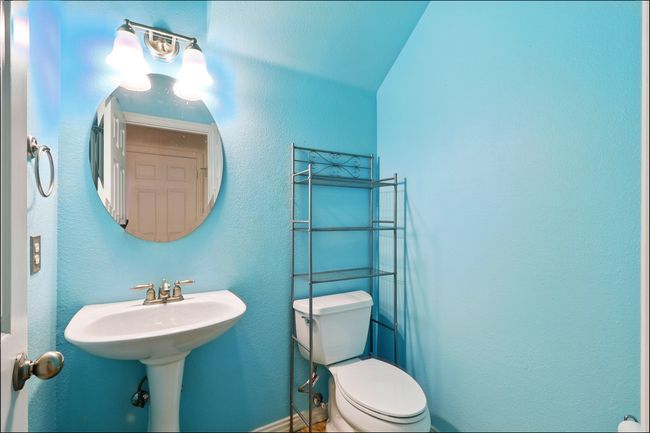 Half Bathroom with a textured wall and toilet | Image 13