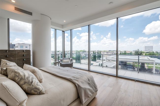 Bedroom featuring access to exterior, hardwood / wood-style flooring, recessed lighting, and a view of city | Image 17