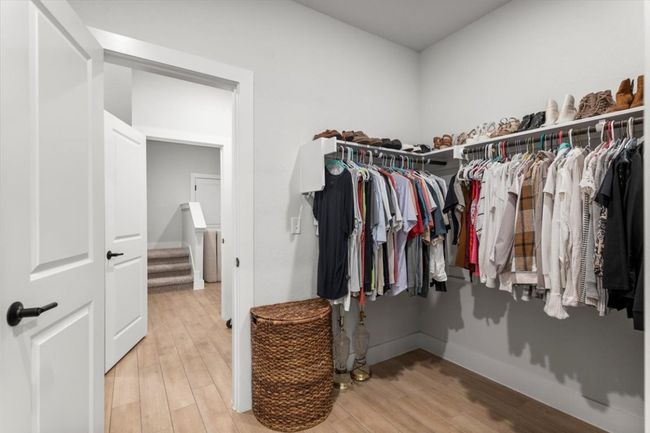 Walk in closet featuring wood finished floors | Image 15