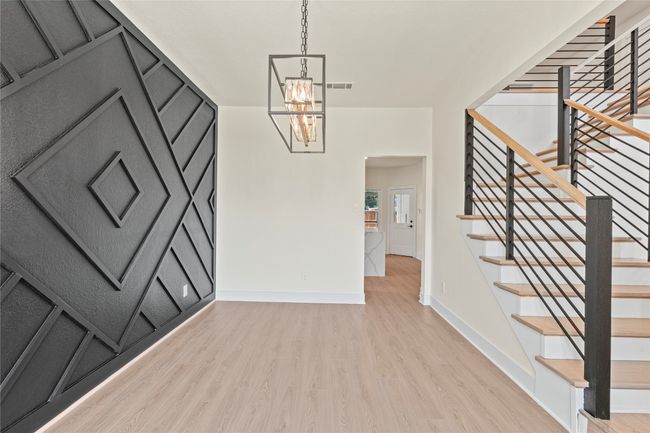 Foyer featuring light wood-style flooring, a chandelier, and stairway | Image 6