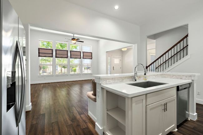 Kitchen with light countertops, a sink, appliances with stainless steel finishes, and dark wood-type flooring | Image 12