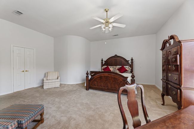 Bedroom with light colored carpet and ceiling fan | Image 29