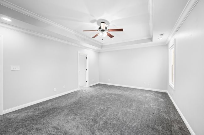 Primary bedroom with tray ceiling. | Image 45