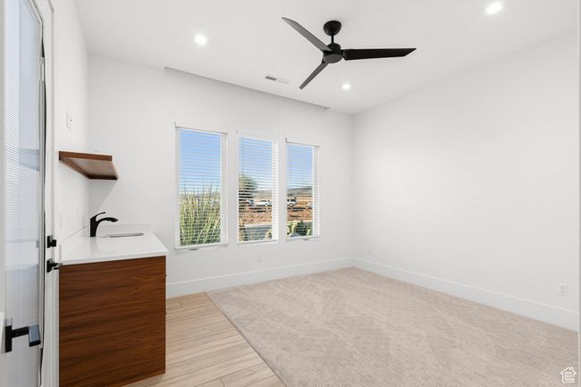 Interior space featuring ceiling fan, visible vents, recessed lighting, a sink, and baseboards | Image 15