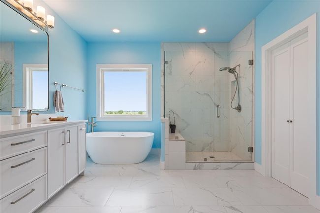 Bathroom featuring a marble finish shower, vanity, a freestanding bath, recessed lighting, and marble finish floors | Image 27