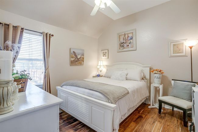 Bedroom with ceiling fan, lofted ceiling, and dark wood-style floors | Image 11