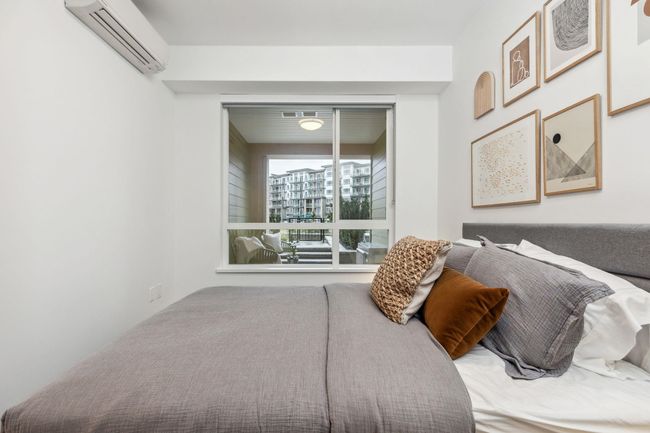 Bedroom featuring a wall mounted AC | Image 11