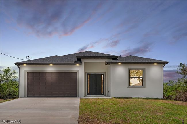 Prairie-style home featuring a garage and a lawn | Image 1