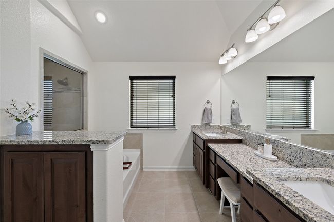 Well-appointed primary bathroom offering a dual vanity, spa-like soaking tub, and separate shower for ultimate comfort. | Image 22