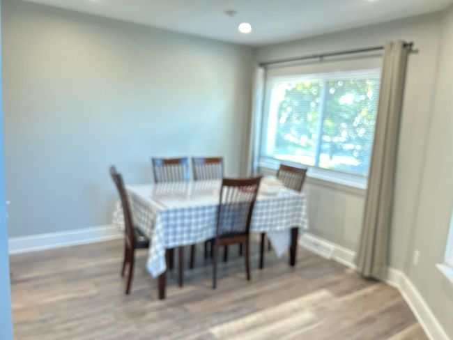Dining space with light wood-style flooring and baseboards | Image 16