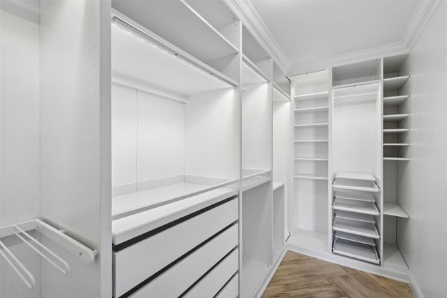 Walk in closet featuring parquet flooring | Image 21