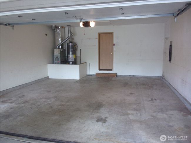 Fully sheet rocked garage with garage door opener. | Image 30