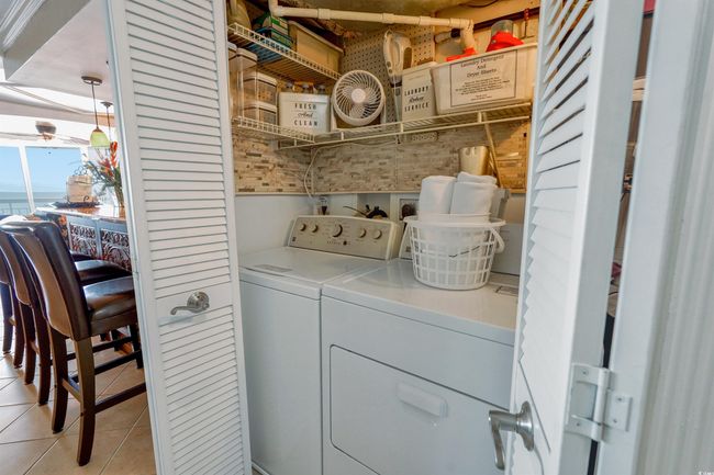Clothes washing area with washer and clothes dryer and light tile patterned floors | Image 21