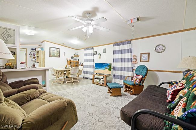 Open concept Living room with vaulted ceiling, and ceiling fan | Image 5