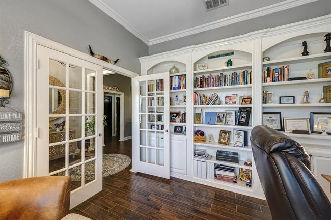 Home office with ornamental molding, french doors, wood finish floors, and visible vents | Image 7