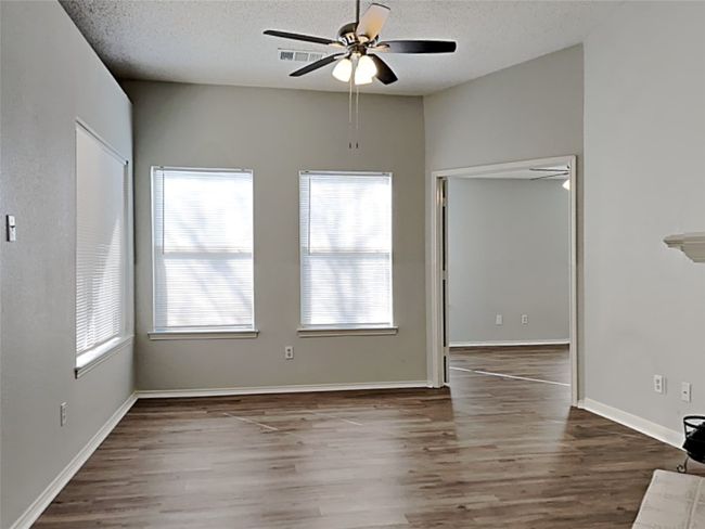 Unfurnished room with wood finished floors, a textured ceiling, and ceiling fan | Image 4