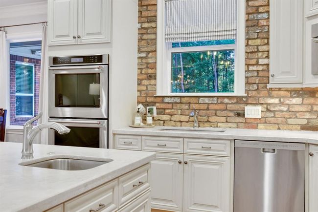 The cook in the family will truly appreciate the abundant counter space, offering plenty of room for meal prep, serving, and gathering. The inclusion of double sinks adds both convenience and flexibility—perfect for multitasking during meal planning, entertaining, or everyday family dinners. | Image 14