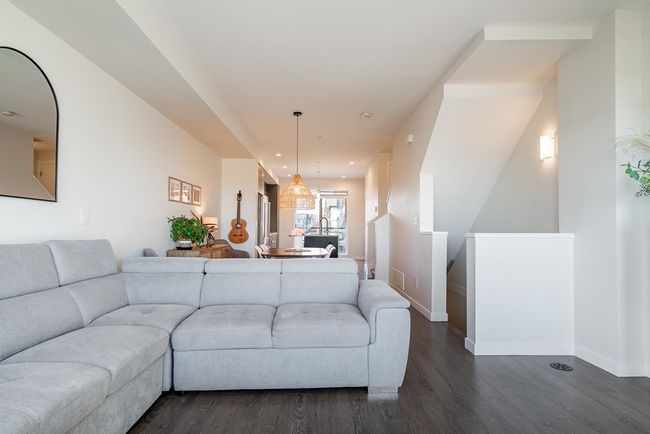 Living room with dark wood finished floors, recessed lighting, and baseboards | Image 16