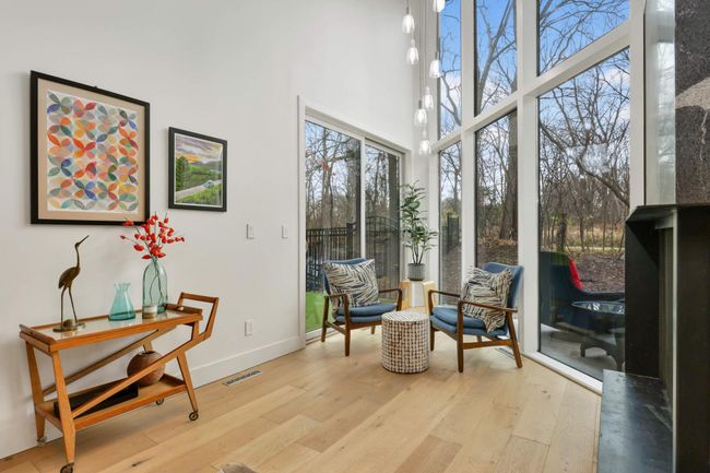 Sunroom has 2 story windows and patio door | Image 11
