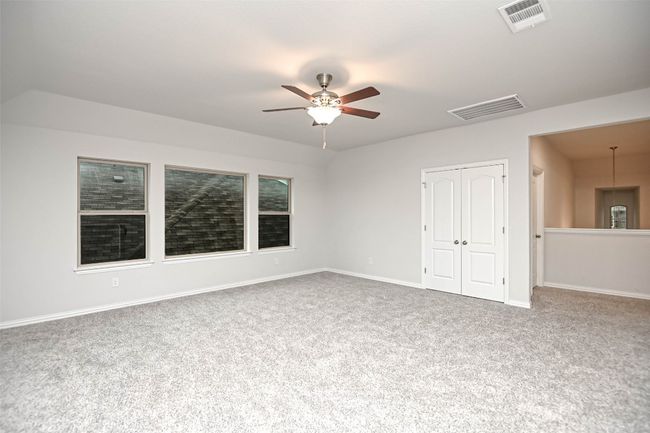 Carpeted spare room with baseboards, visible vents, and a ceiling fan | Image 24