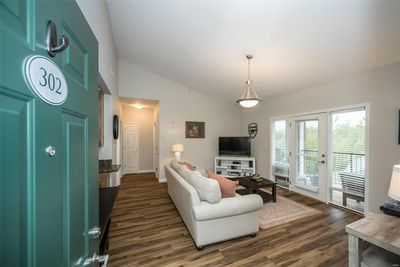 Living room featuring lofted ceiling and new | Image 3