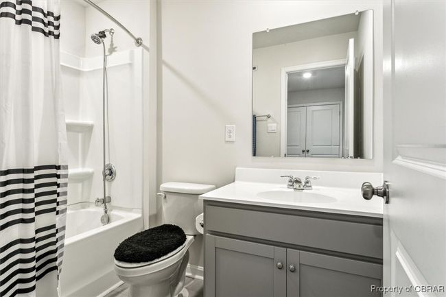 Full bathroom featuring toilet, vanity, and shower / tub combo with curtain | Image 25