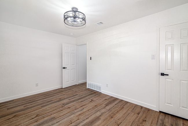 Unfurnished room with wood finished floors and baseboards | Image 31