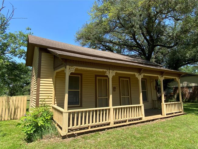 View of front facade featuring covered porch and a shingled roof | Image 10