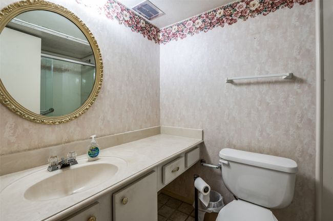 Bathroom featuring vanity, wallpapered walls, a shower with shower door, and tile patterned flooring | Image 21