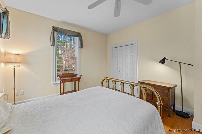 Bedroom featuring wood finished floors, a closet, and a ceiling fan | Image 35