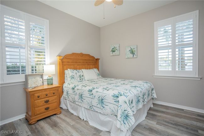 Bedroom featuring multiple windows, baseboards, and vinyl finished floors | Image 12