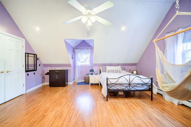 Bedroom 2 featuring lofted ceiling and multiple windows | Image 28