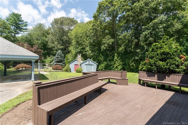 Wood deck with built-in benches is just a few steps off the large level yard. | Image 23