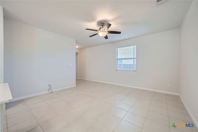 Abundant natural light floods the space, enhancing the ceramic tile flooring and offering a welcoming environment for family and friends. | Image 3